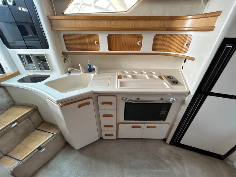 Slide: The Image of Interior of 1993 Sea Ray 440 Sundancer with TV and mirror. - 49