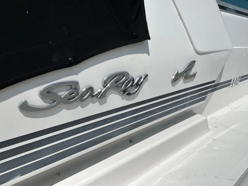 Slide: The Image of 1993 Sea Ray 440 Sundancer boat logo and model name on white hull. - 5