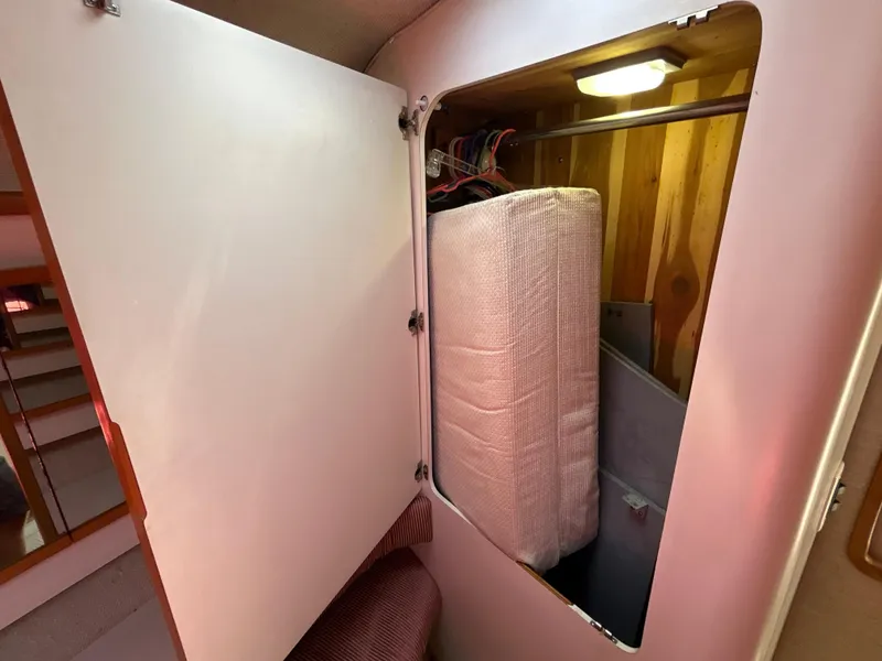 Slide: The Image of Interior of 1993 Sea Ray 440 Sundancer yacht with plush seating and wooden accents. - 63