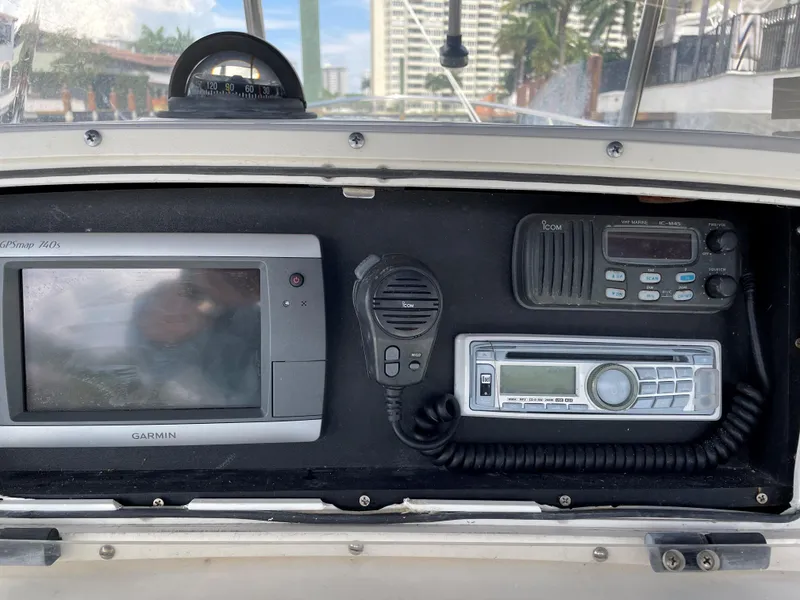 Slide: The Image of 1999 Boston Whaler Outrage 23 dashboard with Garmin GPS, radio, and communication equipment. - 10