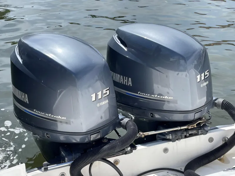 Slide: The Image of Twin Yamaha 115 outboard motors on a 1999 Boston Whaler Outrage 23 boat. - 20