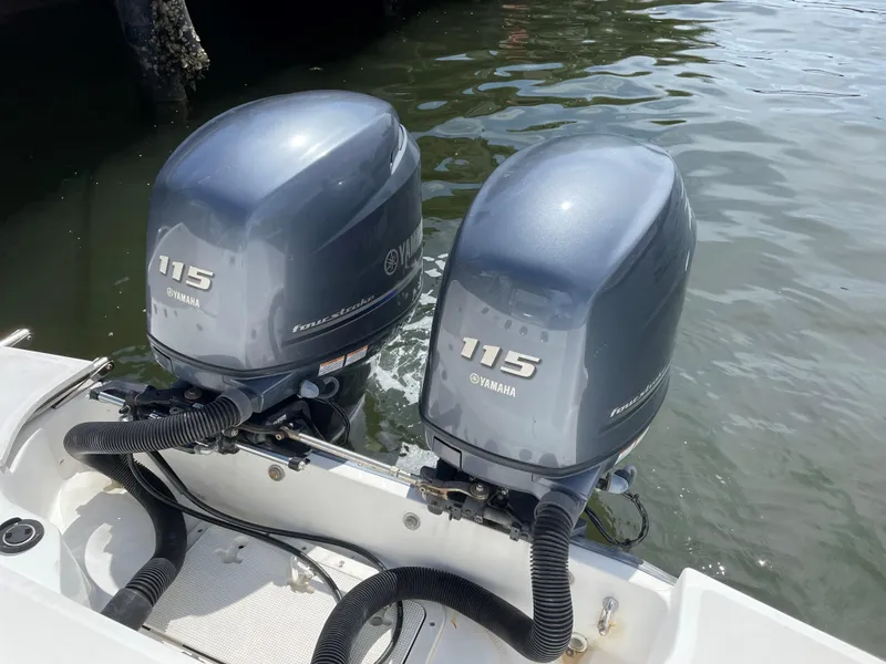 Slide: The Image of Twin Yamaha 115 outboard motors on a 1999 Boston Whaler Outrage 23 boat. - 21