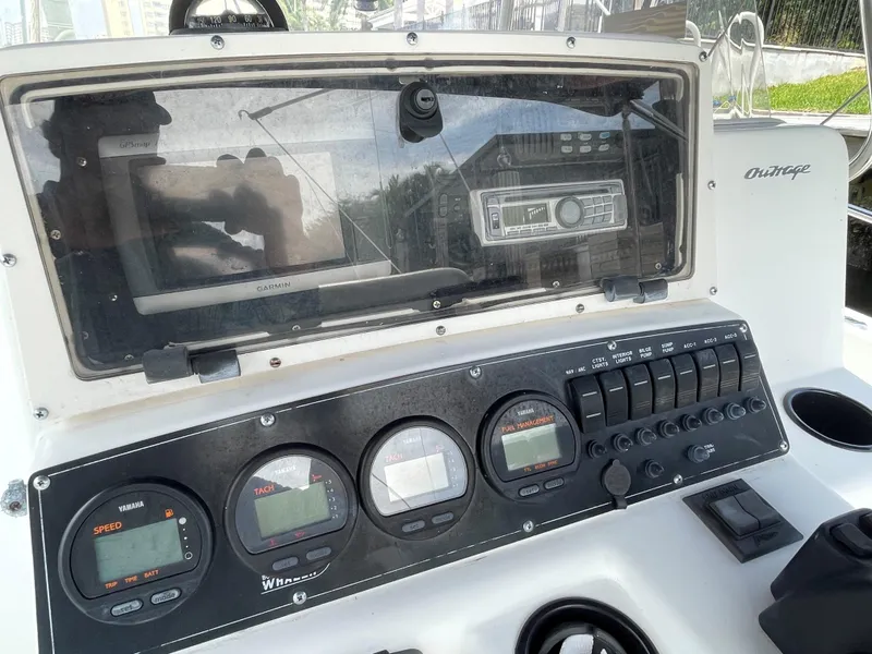 Slide: The Image of 1999 Boston Whaler Outrage 23 dashboard with gauges and navigation equipment. - 9