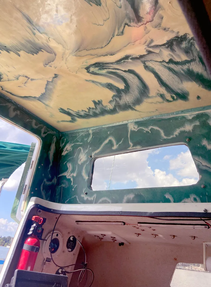 Slide: The Image of Interior of a 1990 Corsair F27 boat with a marbled ceiling design. - 12