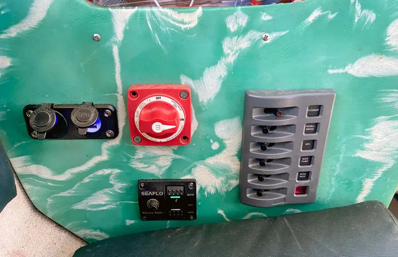 Slide: The Image of Control panel of a 1990 Corsair F27 boat with switches and USB ports. - 14