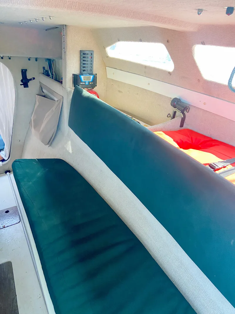 Slide: The Image of Interior of a 1990 Corsair F27 sailboat with seating and navigation equipment. - 16