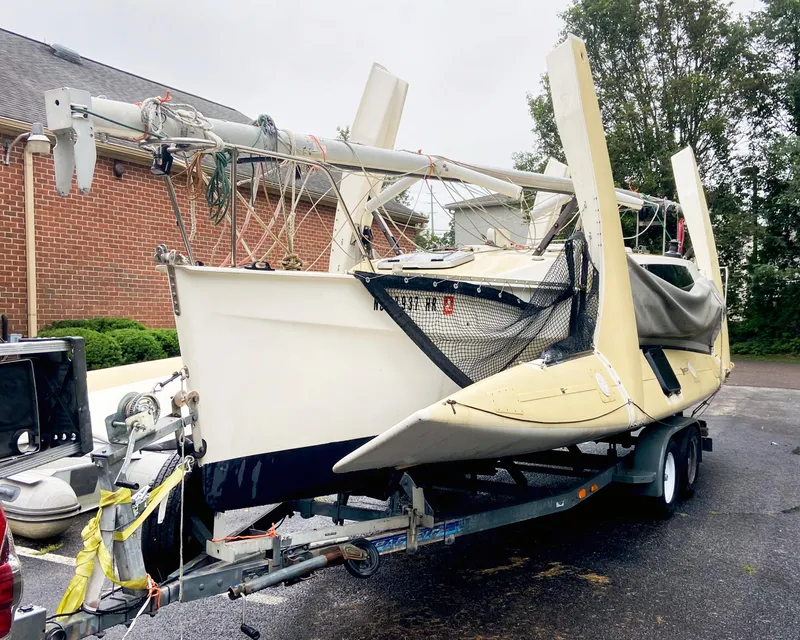 Slide: The Image of 1990 Corsair F27 trimaran on trailer, parked outdoors near brick building. - 3