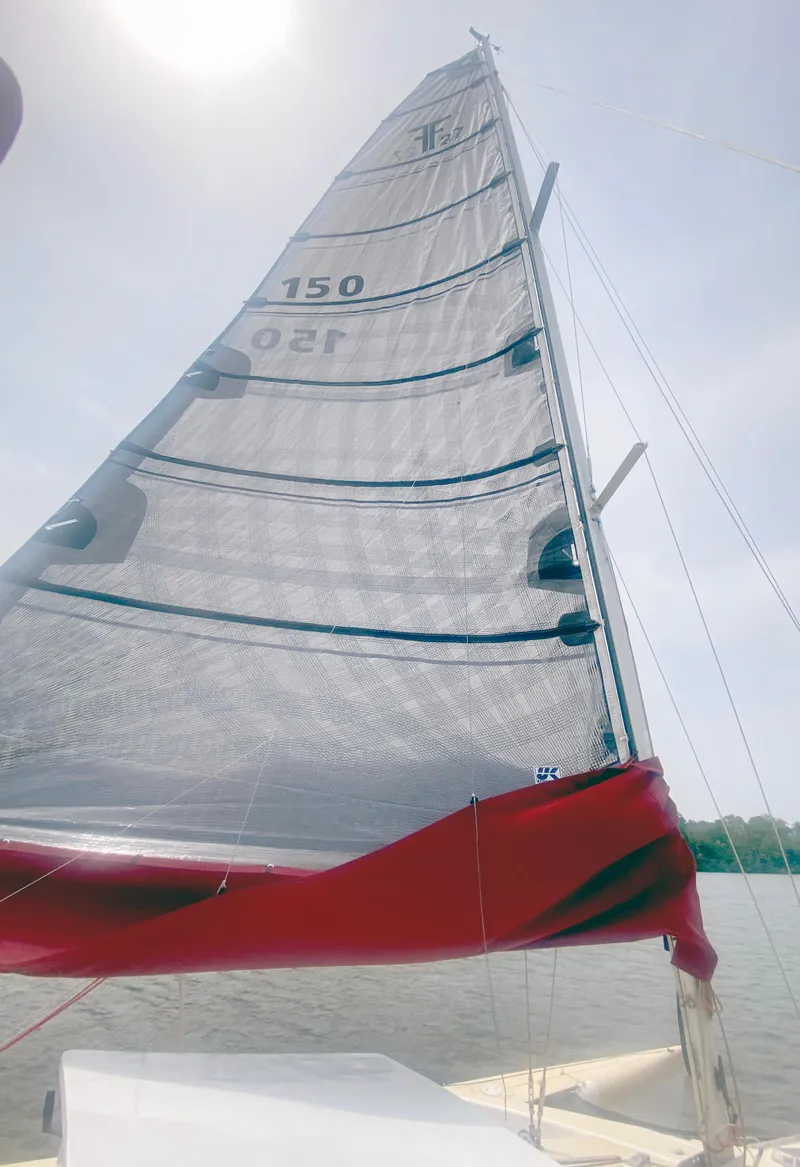Slide: The Image of Sailboat with a tall sail, Corsair F27, 1990 model, on a sunny day. - 7