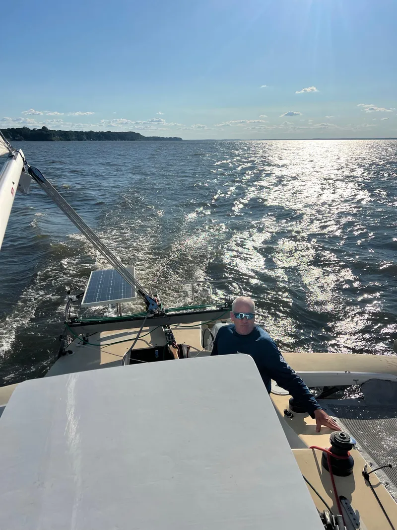 Slide: The Image of Sailing on a 1990 Corsair F27 trimaran under sunny skies, with glistening water. - 9