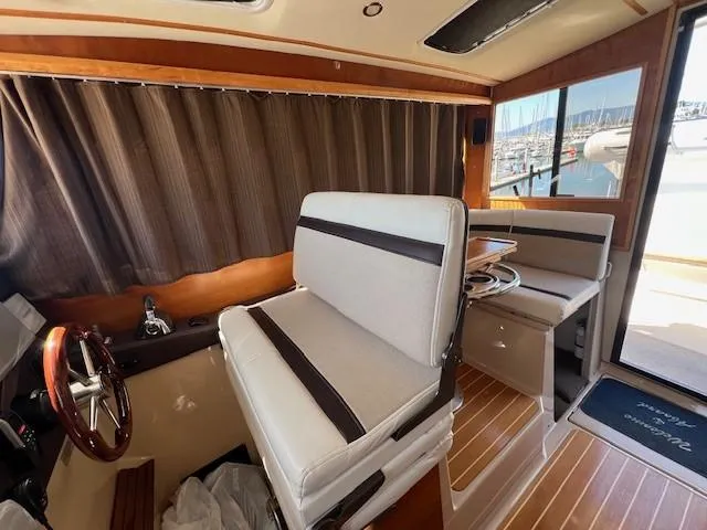 Slide: The Image of Interior of 2016 Cutwater 26 boat with seating and wooden flooring. - 10
