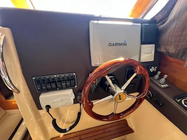 Slide: The Image of Helm of 2016 Cutwater 26 boat with Garmin navigation system and wooden steering wheel. - 11