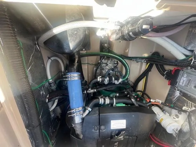 Slide: The Image of Engine compartment of a 2016 Cutwater 26 boat, showcasing various hoses and components. - 18