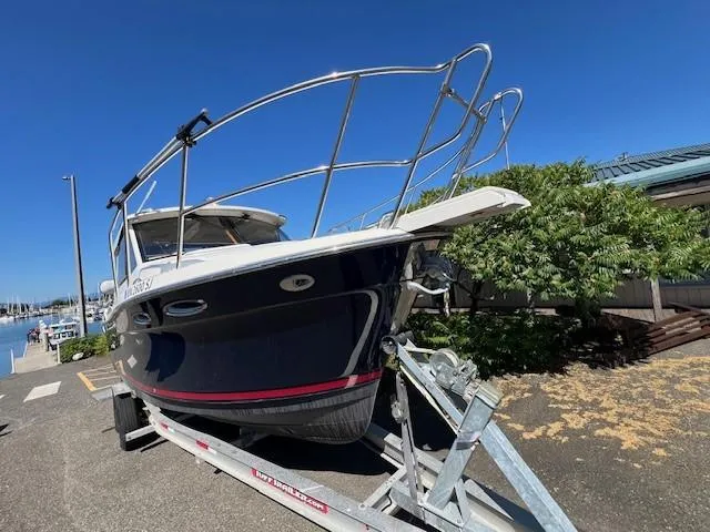 Slide: The Image of 2016 Cutwater 26 boat on trailer, dockside, under clear blue sky. - 2