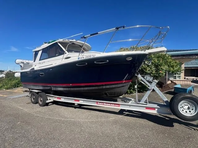 Slide: The Image of 2016 Cutwater 26 boat on trailer under clear blue sky. - 3