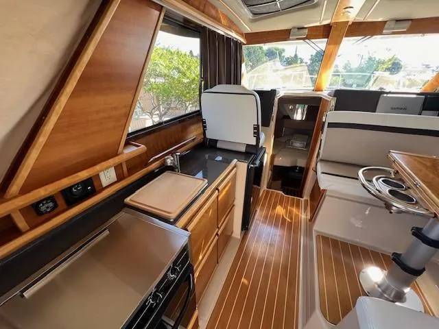 Slide: The Image of Interior of 2016 Cutwater 26 boat with wood finishes and modern amenities. - 6