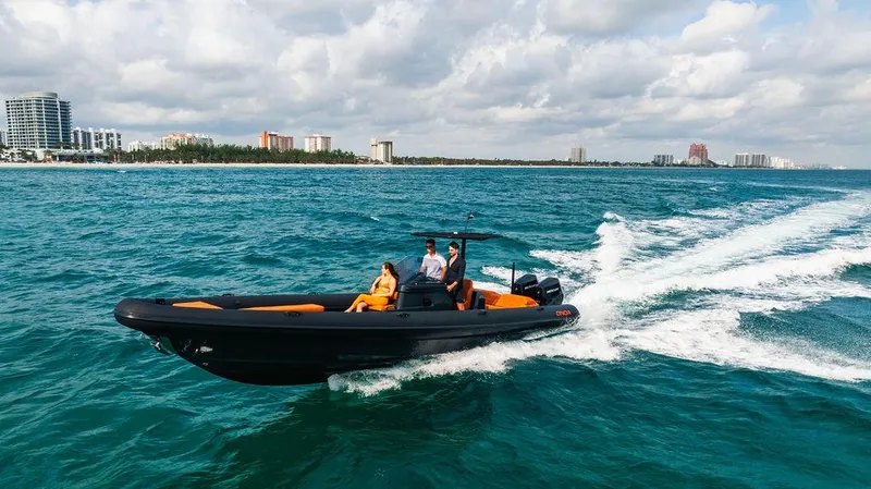 Slide: The Image of 2025 Onda Magna boat cruising on ocean near city skyline under cloudy sky. - 15