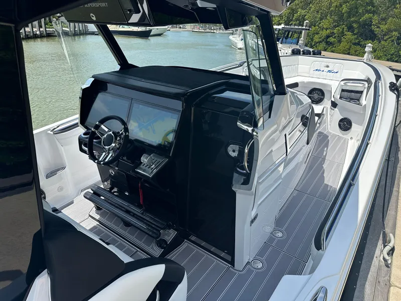 Slide: The Image of 2024 Nor-Tech 400 Supersport boat interior with sleek dashboard and modern controls. - 13