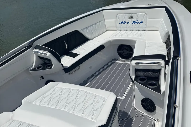 Slide: The Image of 2024 Nor-Tech 400 Supersport boat interior with luxurious white seating and cup holders. - 16