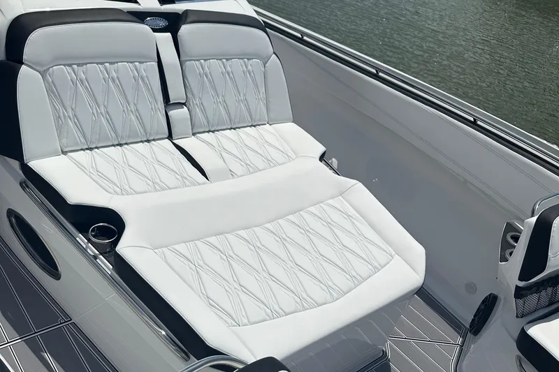 Slide: The Image of 2024 Nor-Tech 400 Supersport luxury seating with elegant white upholstery on a boat. - 18