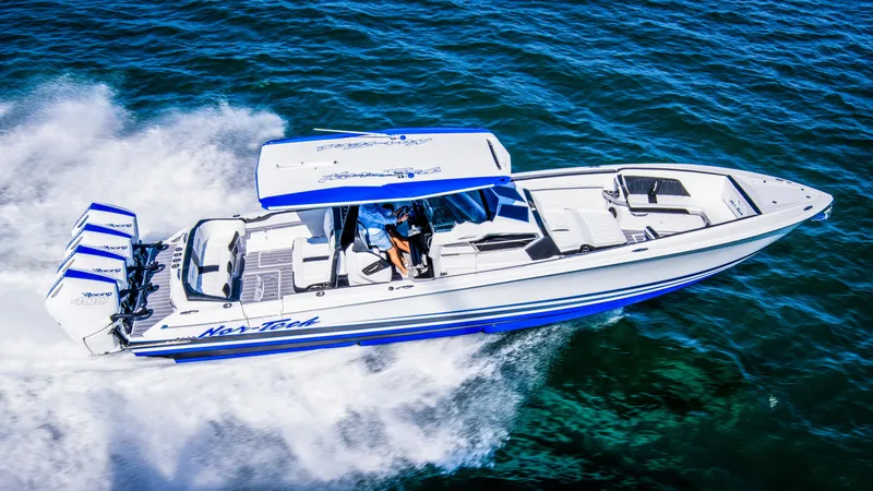 Slide: The Image of 2024 Nor-Tech 400 Supersport speedboat cruising on open water, showcasing sleek design and powerful engines. - 2