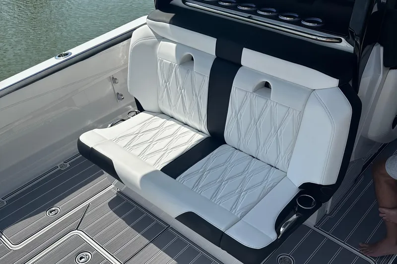 Slide: The Image of Luxurious seating on 2024 Nor-Tech 400 Supersport boat, featuring elegant white and black upholstery. - 21