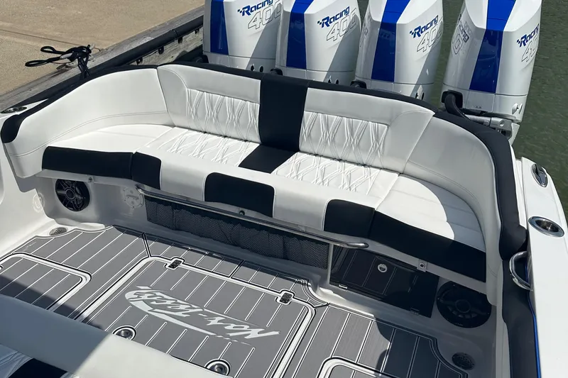 Slide: The Image of 2024 Nor-Tech 400 Supersport boat with white seating and powerful engines. - 22