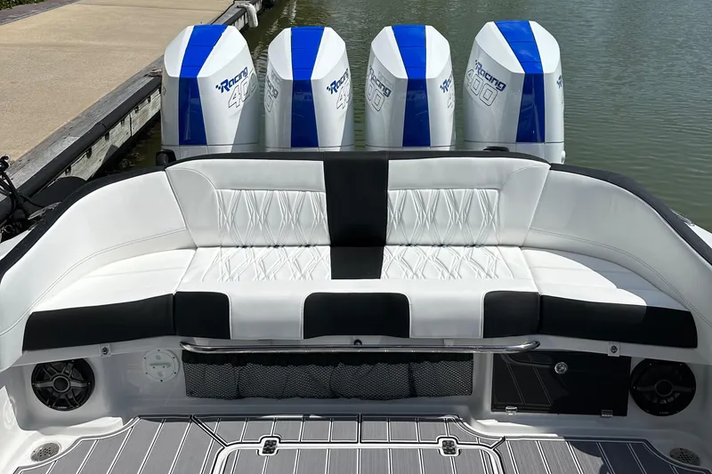 Slide: The Image of 2024 Nor-Tech 400 Supersport boat with white seating and four powerful outboard engines. - 23