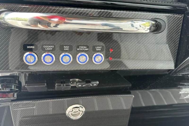 Slide: The Image of Control panel of 2024 Nor-Tech 400 Supersport with labeled buttons and carbon fiber finish. - 27