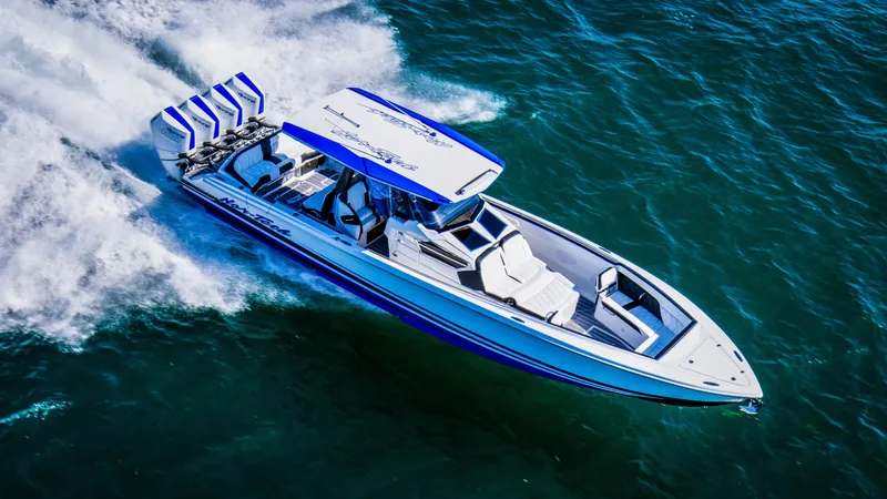 Slide: The Image of 2024 Nor-Tech 400 Supersport speedboat cruising on open water, showcasing sleek design and powerful engines. - 3