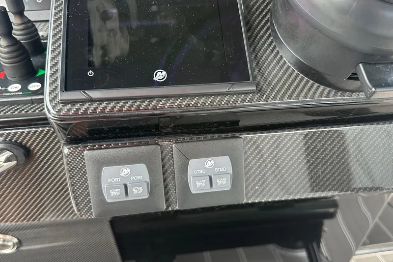 Slide: The Image of 2024 Nor-Tech 400 Supersport dashboard with carbon fiber finish and control buttons. - 30