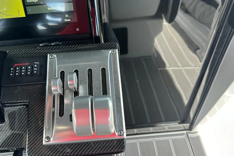 Slide: The Image of Control panel of 2024 Nor-Tech 400 Supersport boat with Mercury throttle levers. - 31
