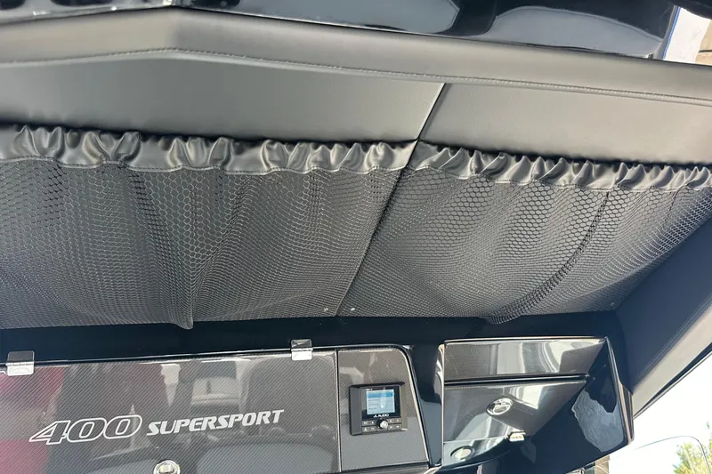 Slide: The Image of 2024 Nor-Tech 400 Supersport interior with sleek black design and storage netting. - 34