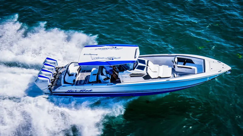 Slide: The Image of 2024 Nor-Tech 400 Supersport speedboat cruising on open water, showcasing sleek design and powerful engines. - 4