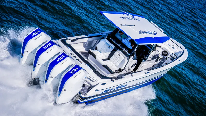 Slide: The Image of 2024 Nor-Tech 400 Supersport boat cruising on open water, featuring four powerful engines. - 5