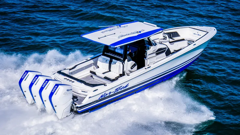 Slide: The Image of 2024 Nor-Tech 400 Supersport boat cruising on open water, showcasing triple outboard engines. - 6