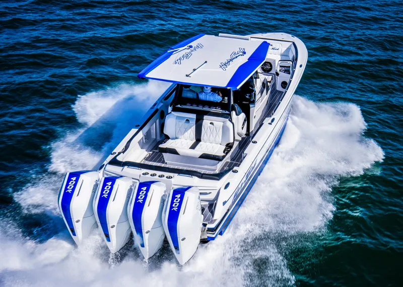 Slide: The Image of 2024 Nor-Tech 400 Supersport speedboat with quad engines cruising on open water. - 7