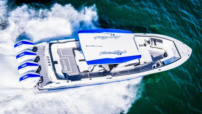 Slide: The Image of 2024 Nor-Tech 400 Supersport boat speeding on water, aerial view. - 9