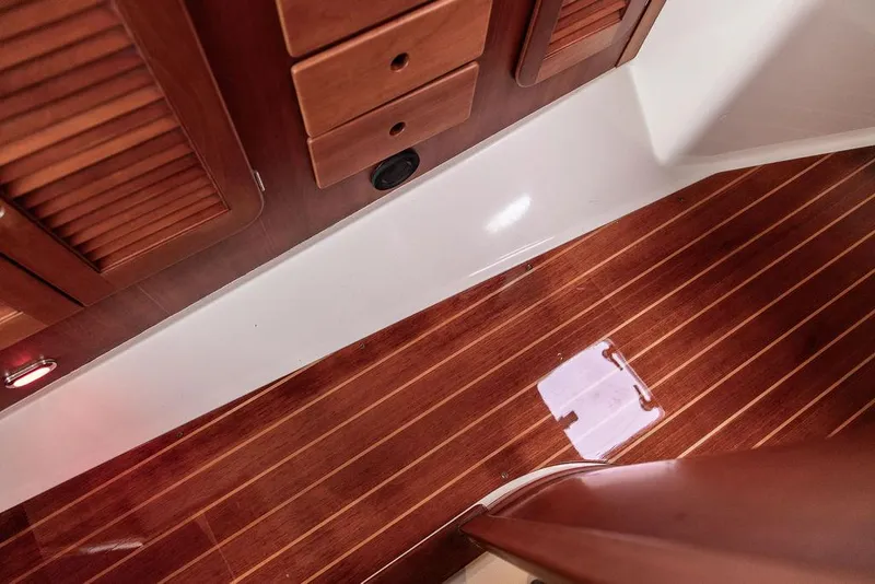 Slide: The Image of Interior of 1998 Hinckley Picnic Boat with polished wooden flooring and cabinetry. - 43