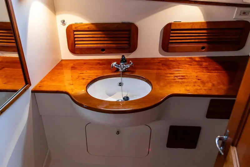 Slide: The Image of Hinckley 1998 Picnic Boat interior with wooden countertop and sink. - 44