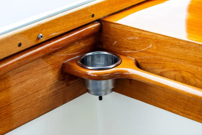 Slide: The Image of Polished wood detail with cup holder on 1998 Hinckley Picnic Boat. - 49