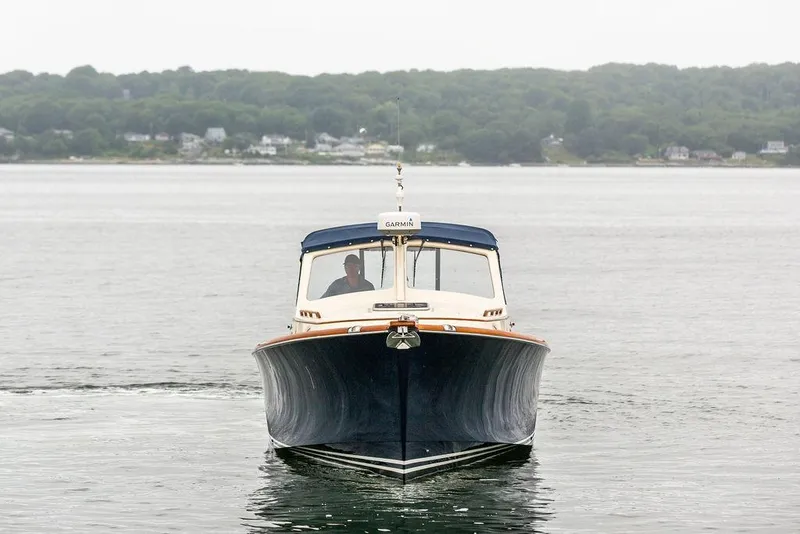 Slide: The Image of 1998 Hinckley Picnic Boat on calm water, distant shoreline in background. - 10