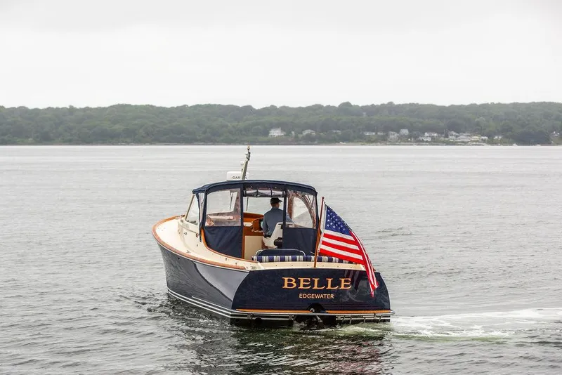 Slide: The Image of 1998 Hinckley Picnic Boat "Belle" cruising on calm waters with American flag. - 5