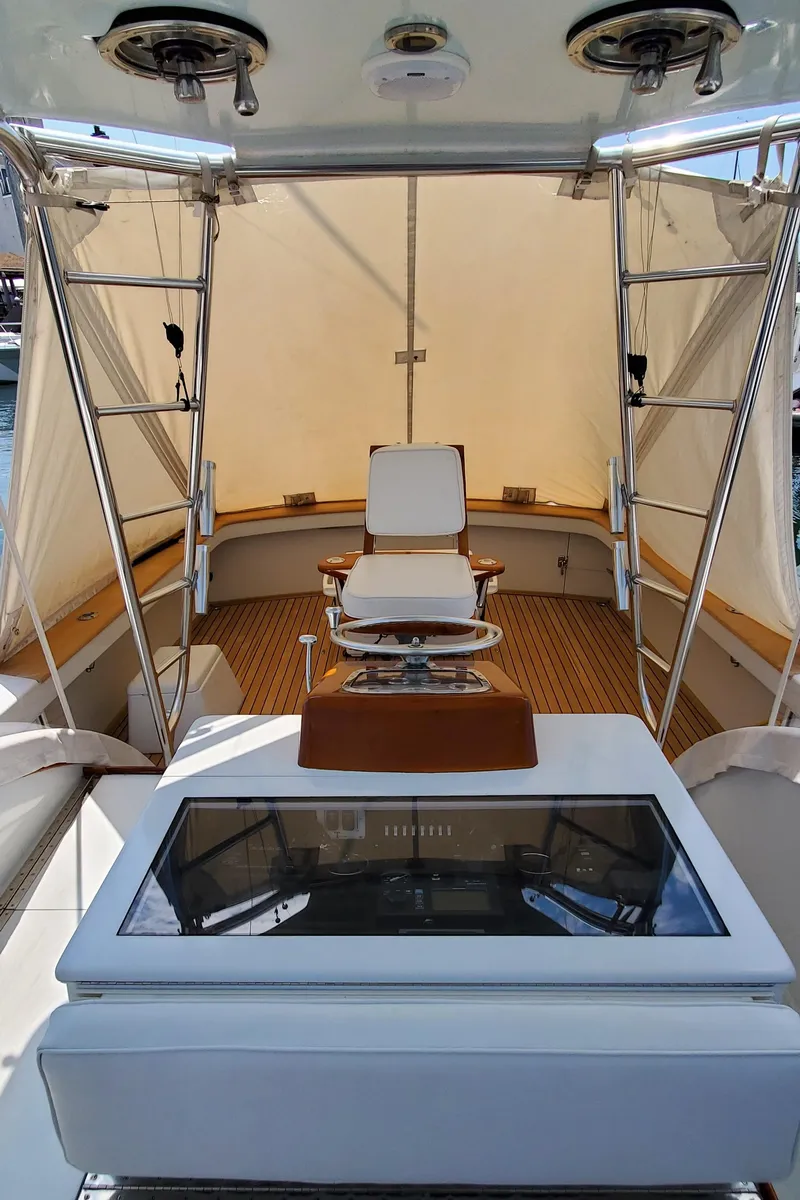 Slide: The Image of 1985 Rybovich 32 Express Walkaround Sportfish boat interior with captain's chair and control panel. - 12