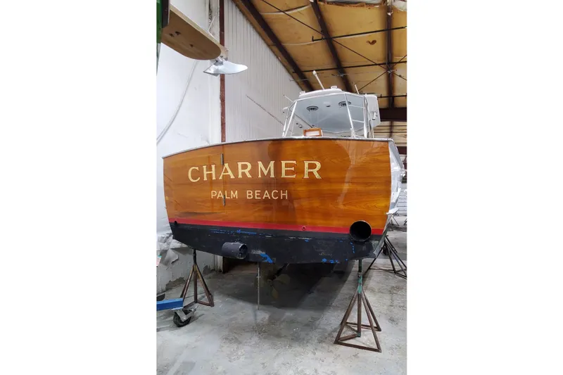 Slide: The Image of 1985 Rybovich 32 Express Walkaround Sportfish boat in a warehouse, named "Charmer." - 21
