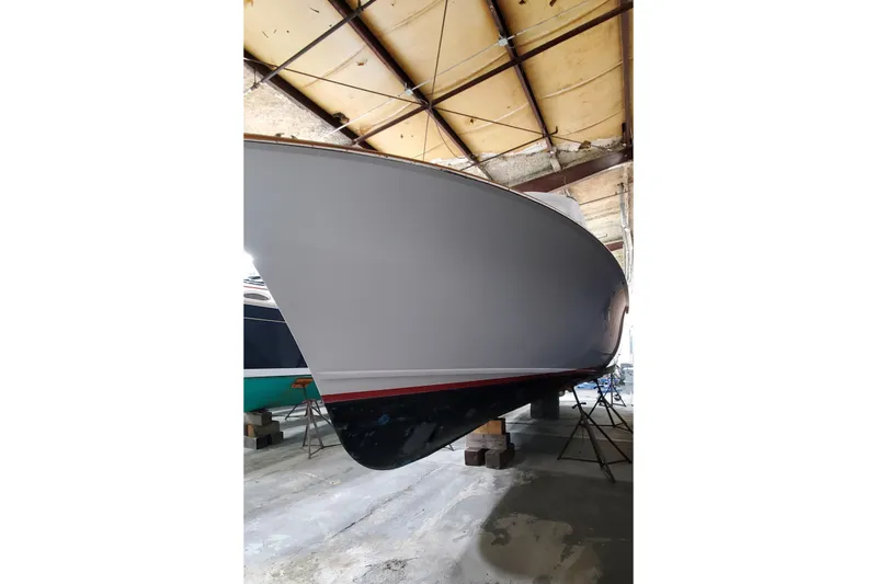 Slide: The Image of 1985 Rybovich 32 Express Walkaround Sportfish in a boatyard, side view. - 24