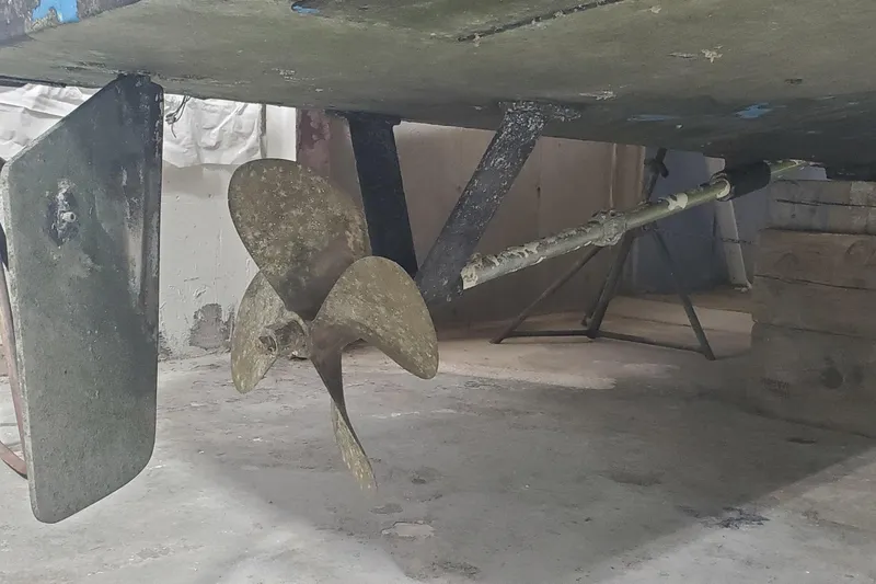 Slide: The Image of Propeller and rudder of a 1985 Rybovich 32 Express Walkaround Sportfish boat in dry dock. - 25