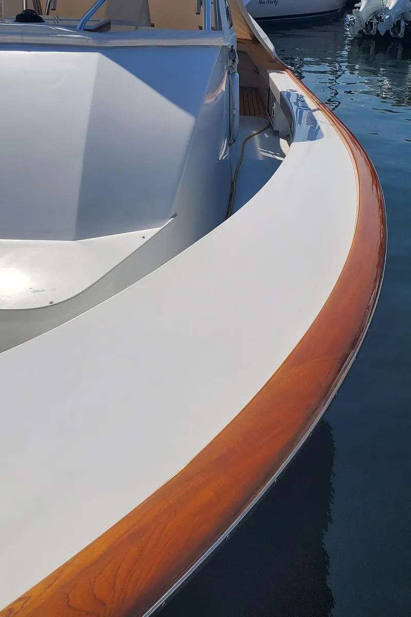 Slide: The Image of 1985 Rybovich 32 Express Walkaround Sportfish boat with sleek wooden trim detail. - 6