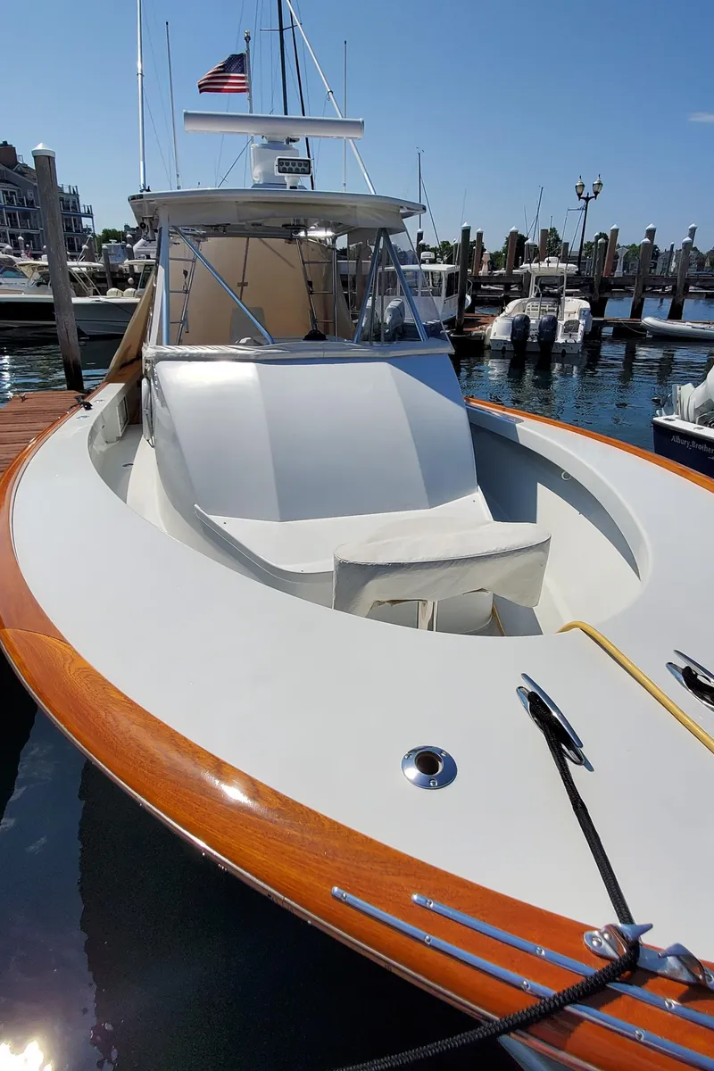 Slide: The Image of 1985 Rybovich 32 Express Walkaround Sportfish docked, featuring sleek design and wooden accents. - 8