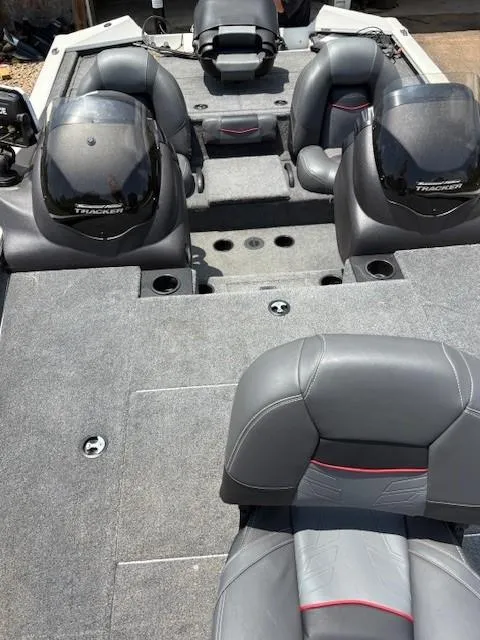 Slide: The Image of 2024 Tracker Pro Team 195 TXW Tournament Edition boat interior with gray seating and dual consoles. - 13