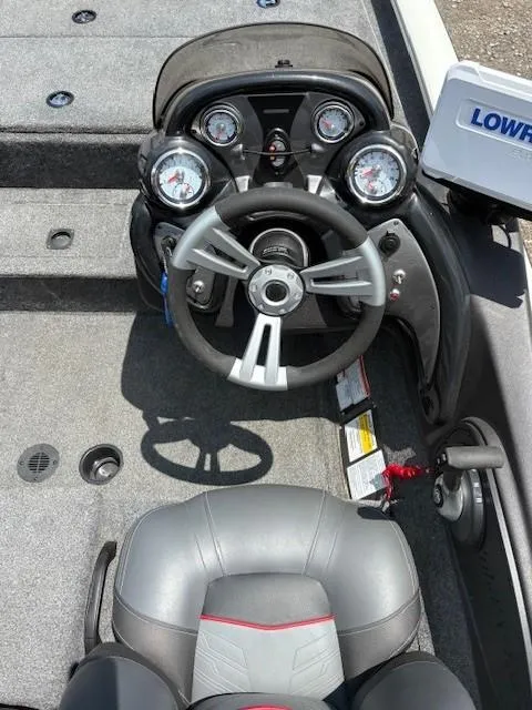 Slide: The Image of 2024 Tracker Pro Team 195 TXW Tournament Edition boat dashboard with steering wheel and gauges. - 7
